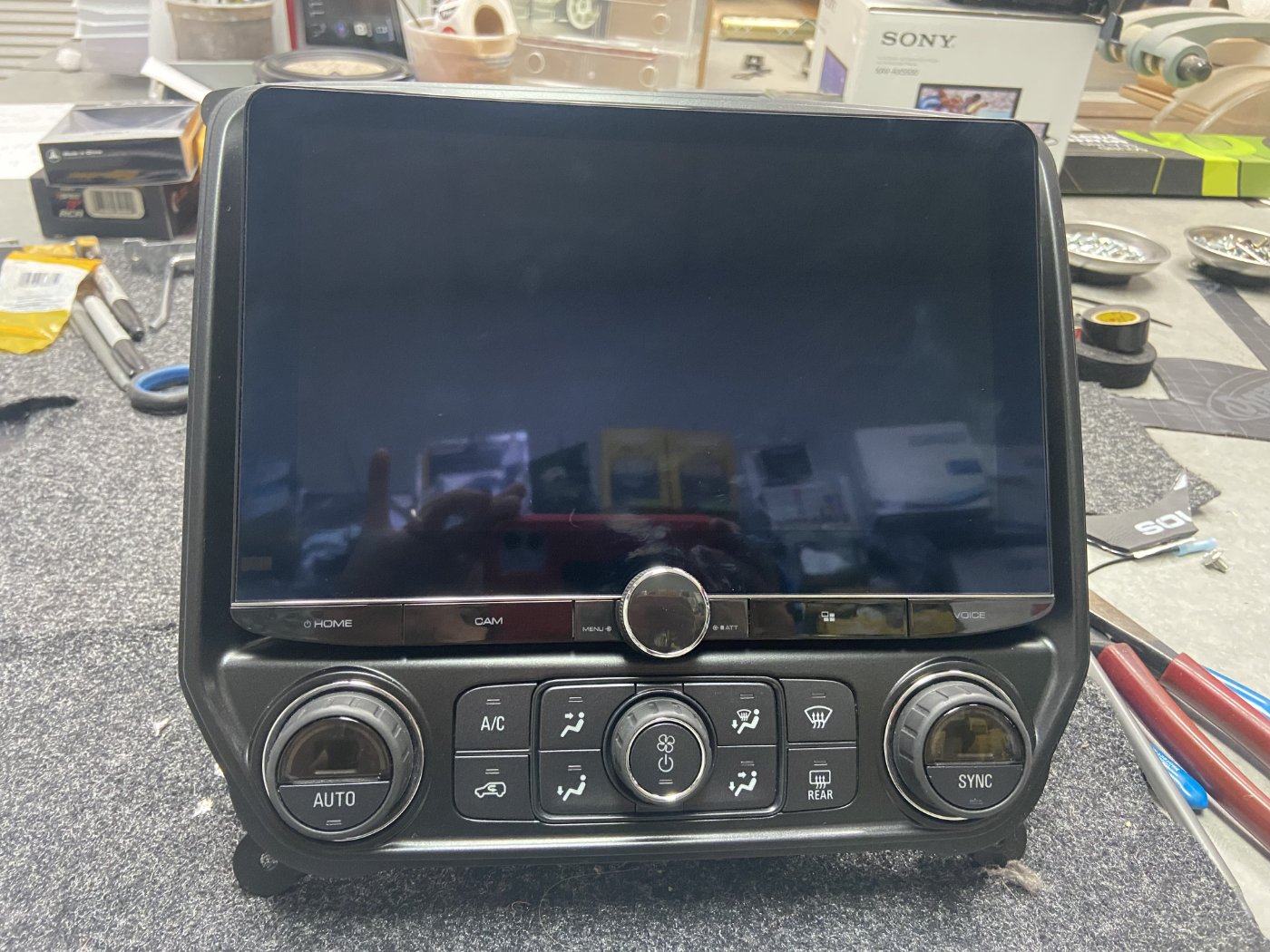 Elite Audio bench work — a head unit and bracketry hand-fitted before it goes in the dash.